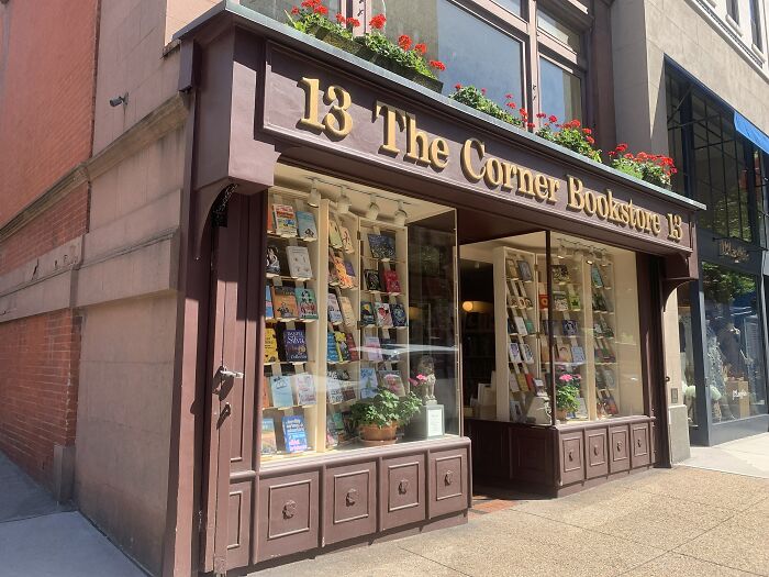 Charming bookstore exterior with flower boxes, showcasing a cosy and magical bookstore from around the world.
